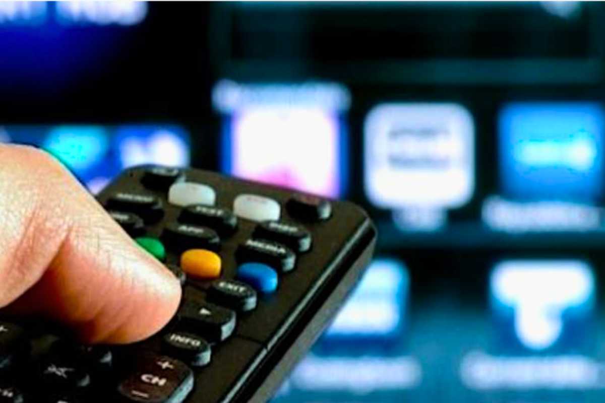 Persona cambia canale alla televisione